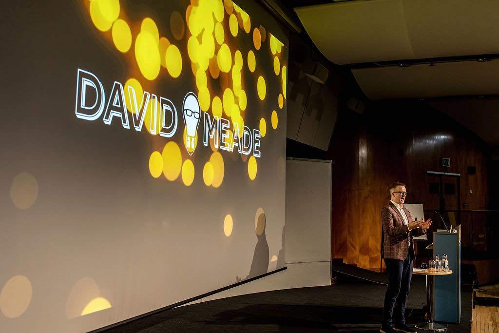 David on stage | Behavioural Science Keynote speaker hosting | David Meade